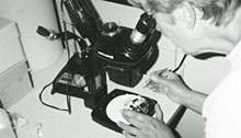 Woman looking into a microscope