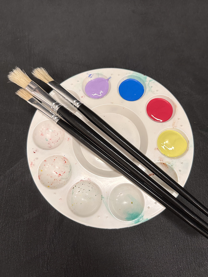 Palette with paint and brushes Palette with paint and brushes