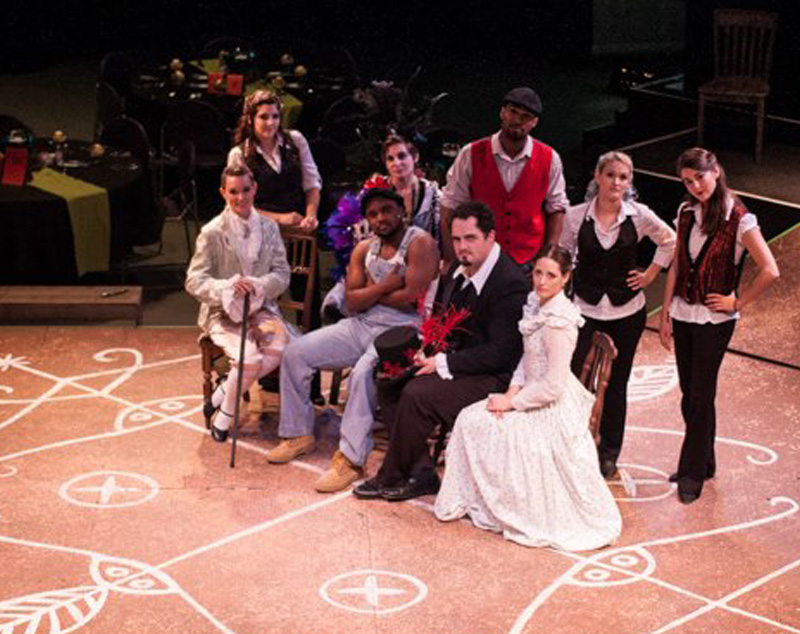 Group of actors onstage with costumes from 1920's