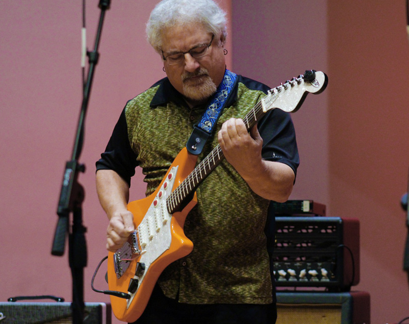 Guy playing guitar onstage
