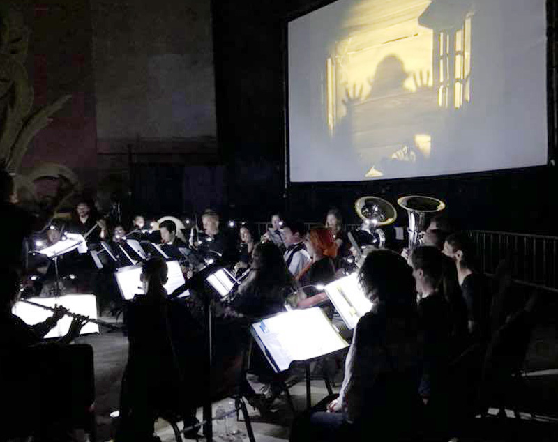 Concert band with Movie Nosferatu playing on a screen
