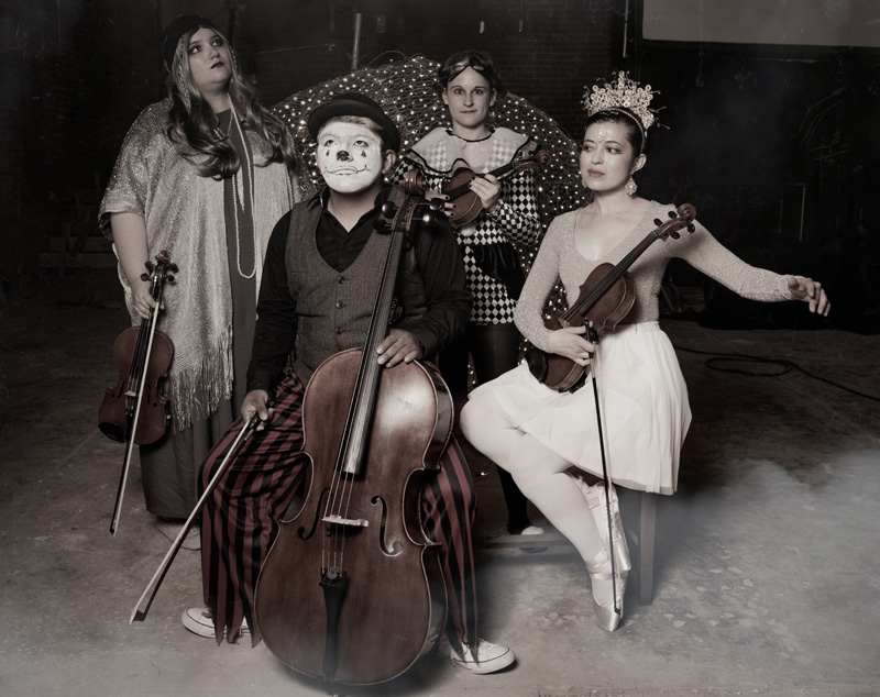 Several members with instruments in circus costumes