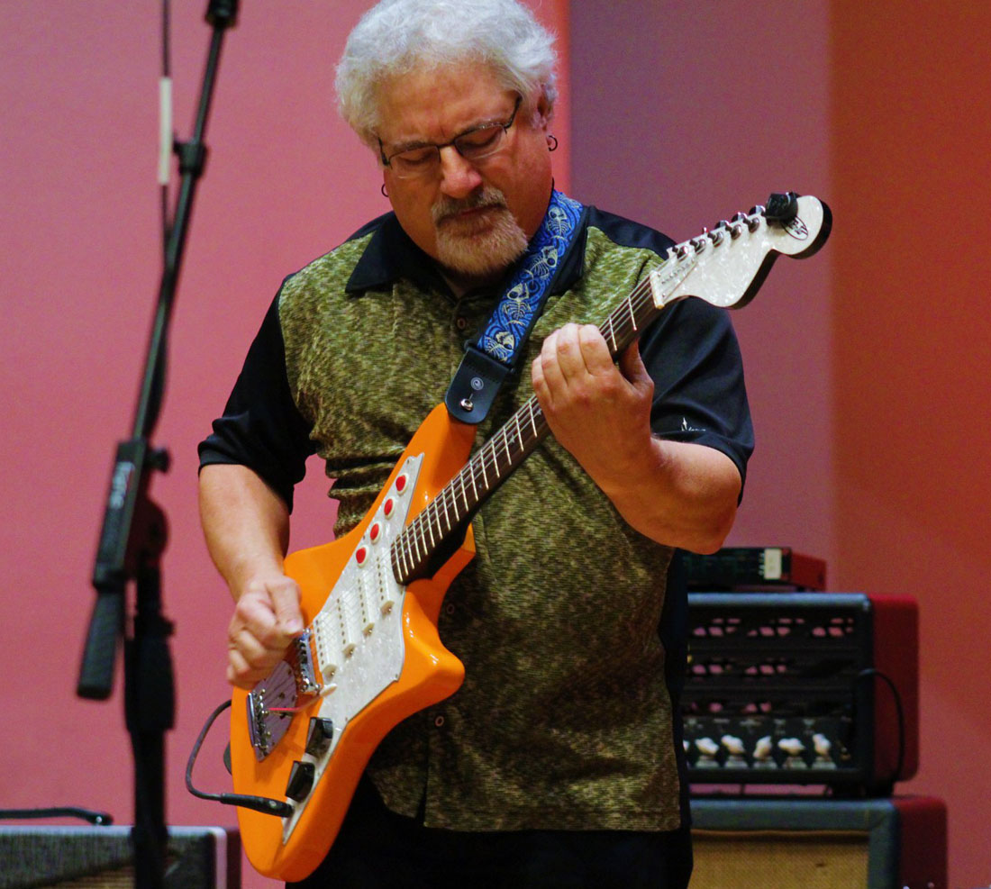 TTU Music faculty Roger Landes playing guitar on stage