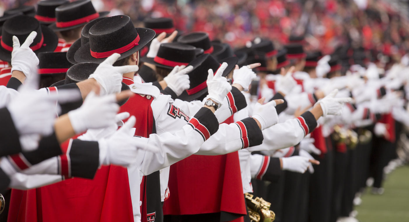 Goin' Band on football field with Guns Up