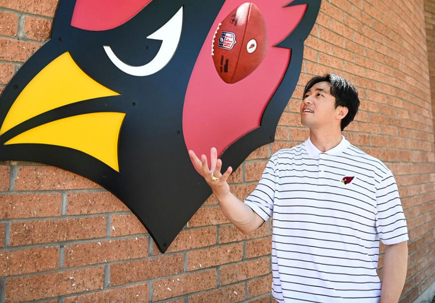 Jianyu (Jay) Yang holding a football