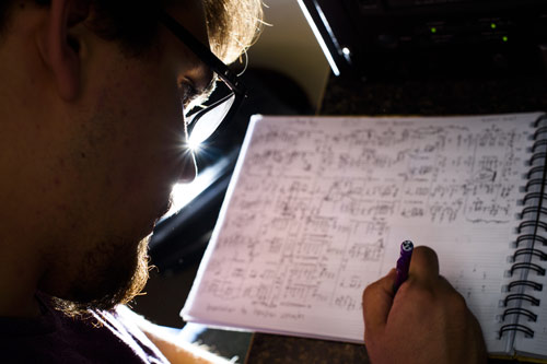 TTU Music student writing music on paper