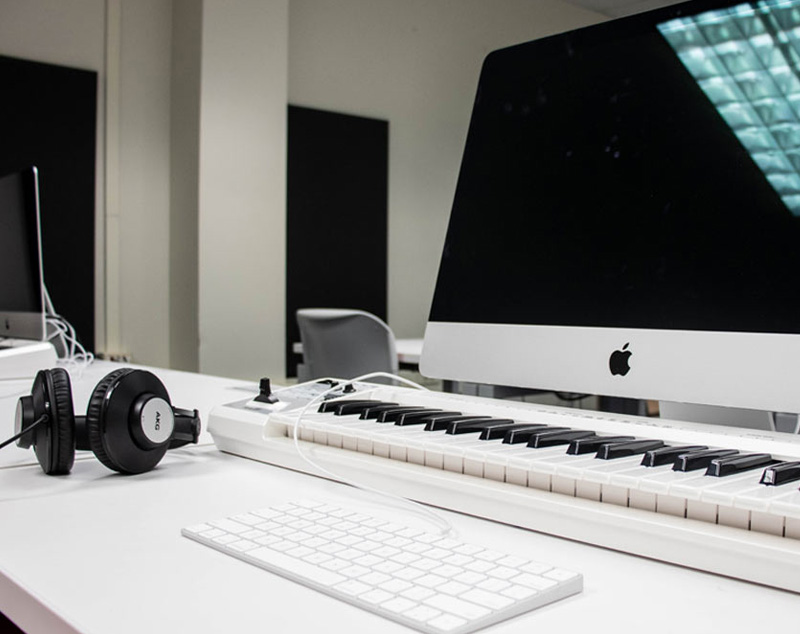 Close up of computer and headphones in music lab