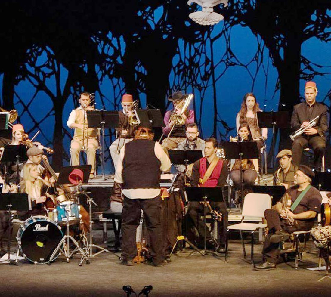 Students on stage with instruments performing