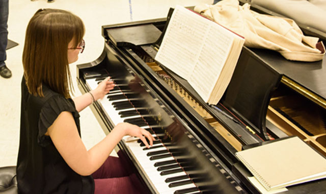 Student playing piano