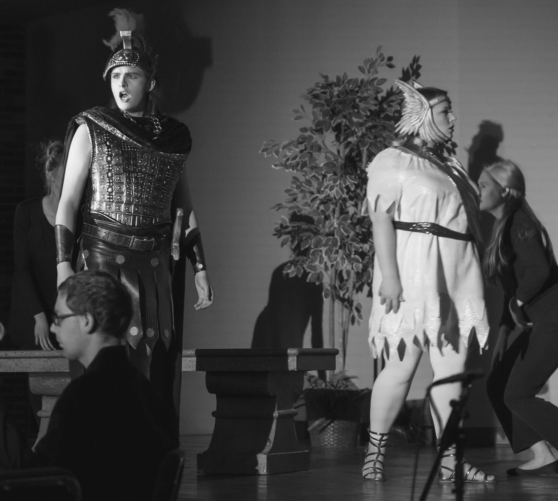 Student in roman legion costume performing opera on stage