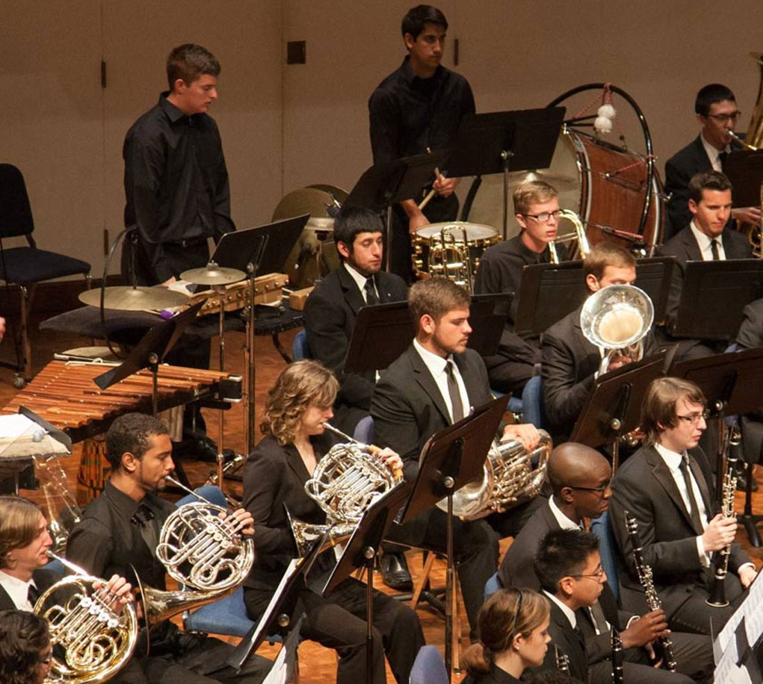 Students performing with instruments in a concert