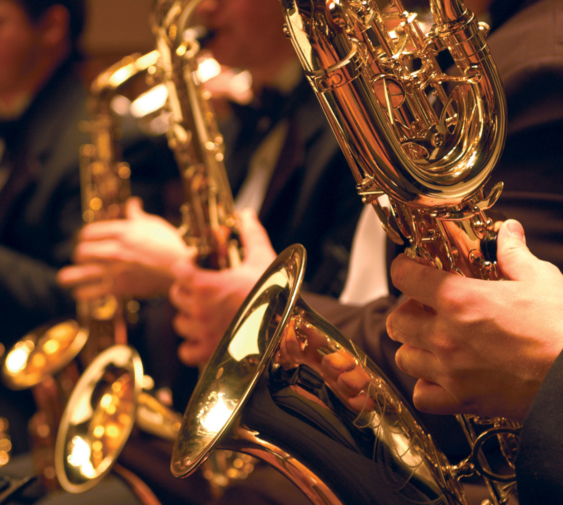 Students playing saxophones in concert
