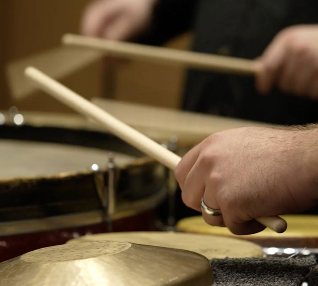 Student playing snares