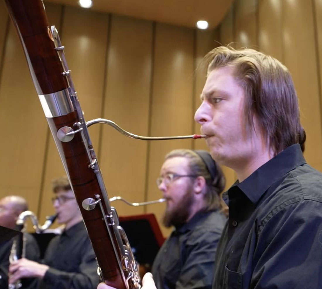 Students playing oboe on stage