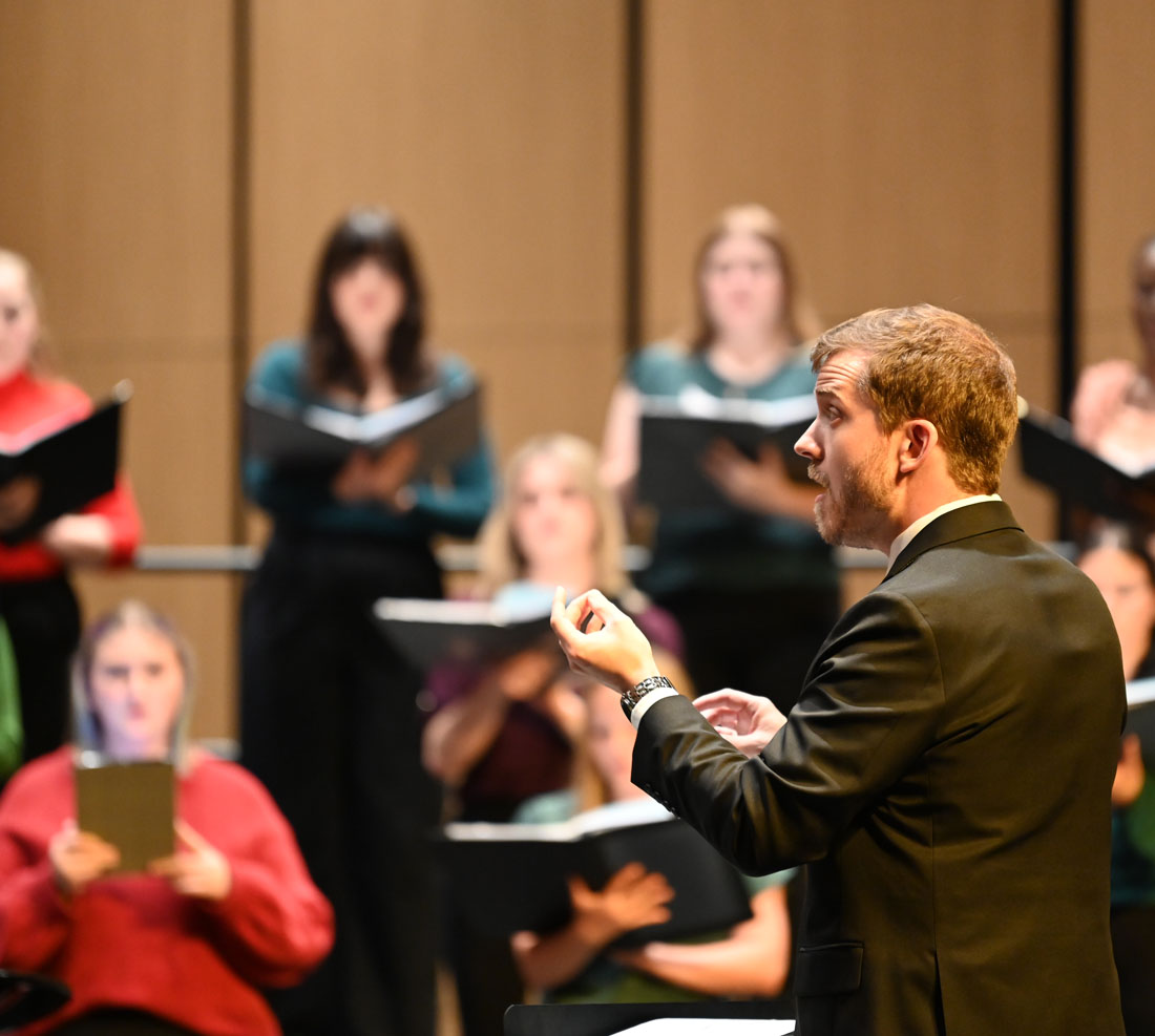 TTU Scarlet Voce singers on stage with conductor