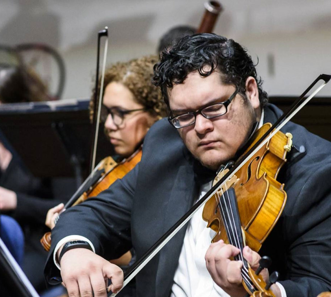 TTU University Symphony Orchestra student playing violin