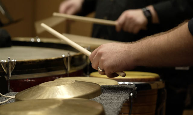 Student playing cymbals in concert
