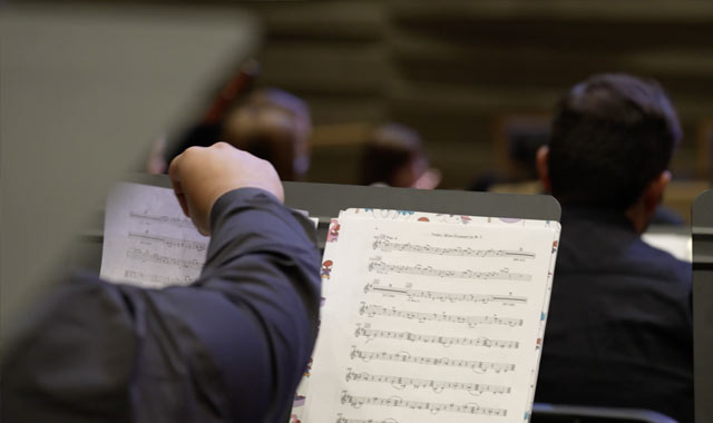 Student turning a music page in concert