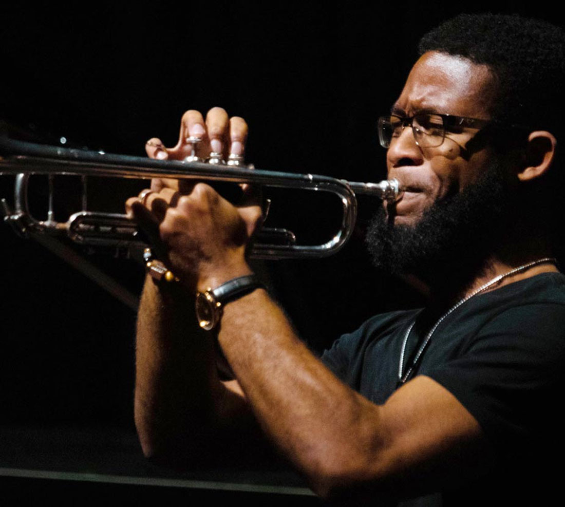 Student playing trumpet on stage