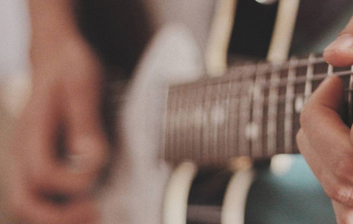 Close up of guitar being played