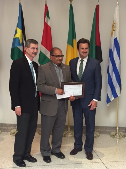 NWI co-founder (center) Dr. Kishor Mehta receives his nomination for Global Vision Award