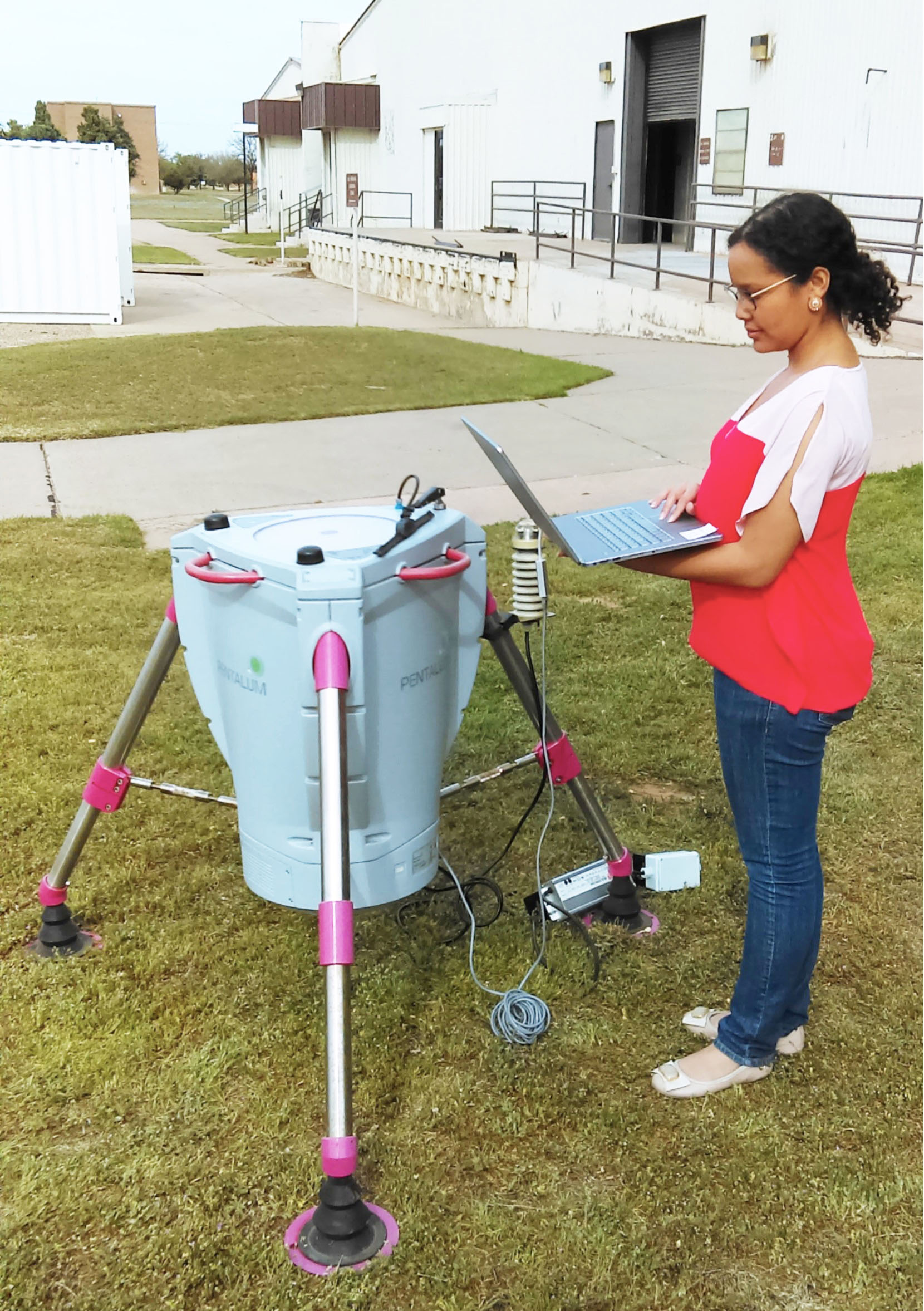 Ph.D. student Tassia Periera stands with LIDAR Ph.D. student Tassia Periera stands with LIDAR