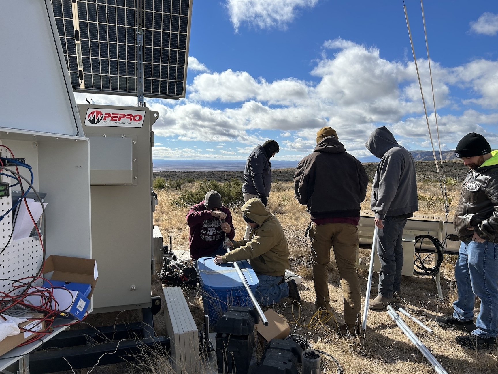 The team building the arms that hold the wind sensors.