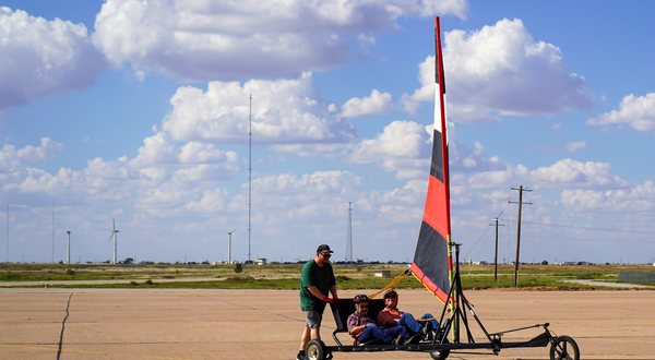 Wind-powered land yacht on the runway apron at the NWI field site, with the instrumented tower behind