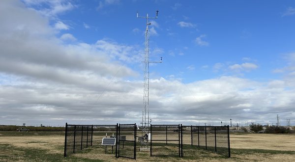 West Texas Mesonet station: an instrumented tower and solar panel inside a fenced enclosure