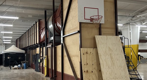 The Boundary Layer Wind Tunnel: a long wood and steel tunnel housing with its main fan duct, inside a laboratory building