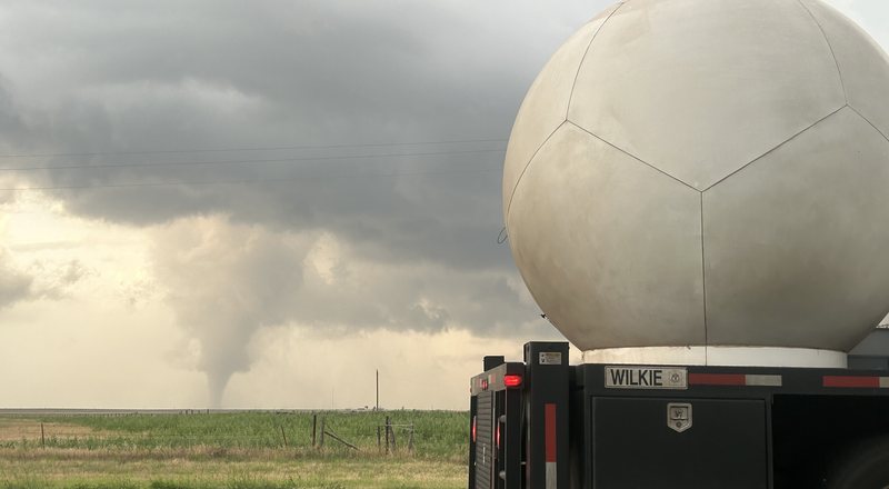 Texas Tech Ka-band mobile radar deployed roadside with a tornado on the horizon