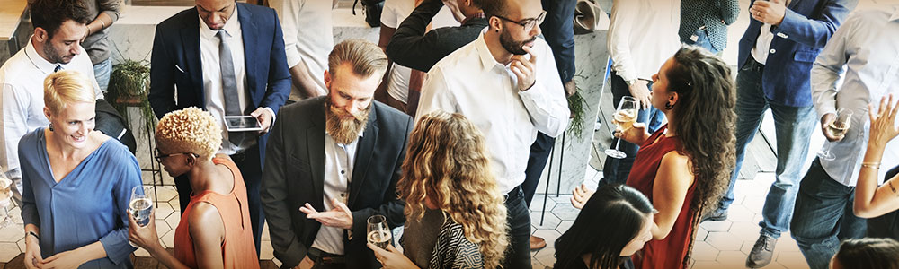 Overhead shot of diverse group of people mingling and conversing.