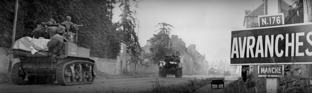  U.S. light tanks passing a road sign for the town of Avranches, southeast of the Falaise Pocket. First U.S. Army's battle against Germans' Operation Luttich in Normandy. August 1-2, 1944.