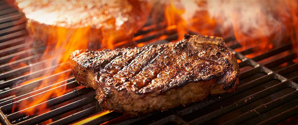 Steaks on a flaming grill