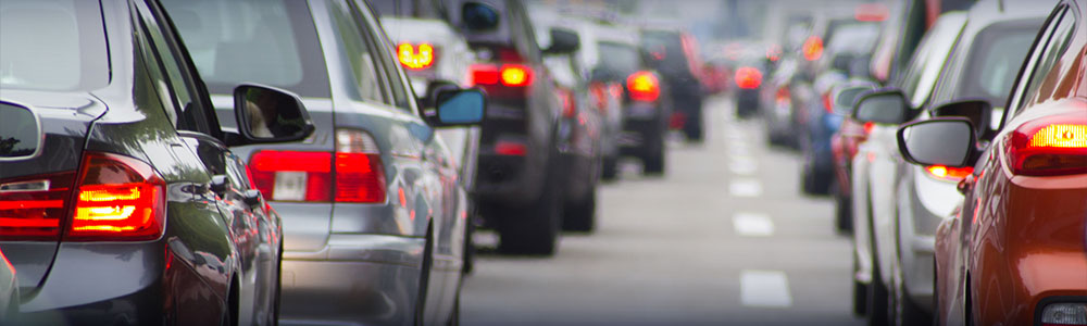  two lanes of traffic filled with cars