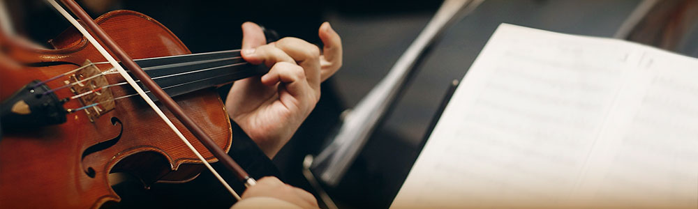 violinists playing with sheet music