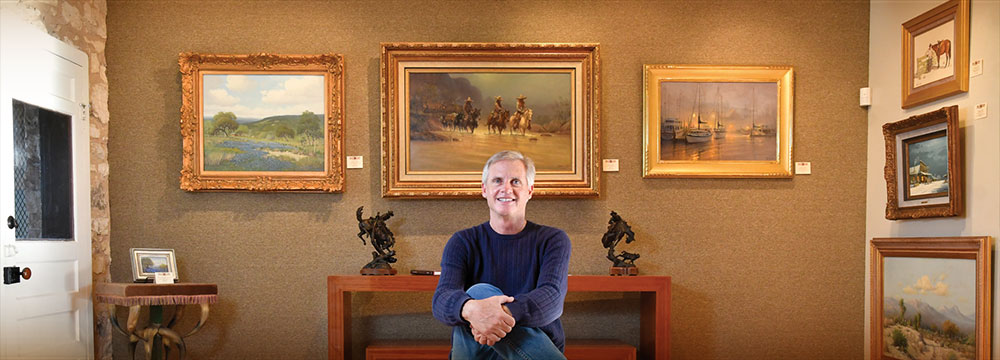 Charles Morin sitting in his art gallery