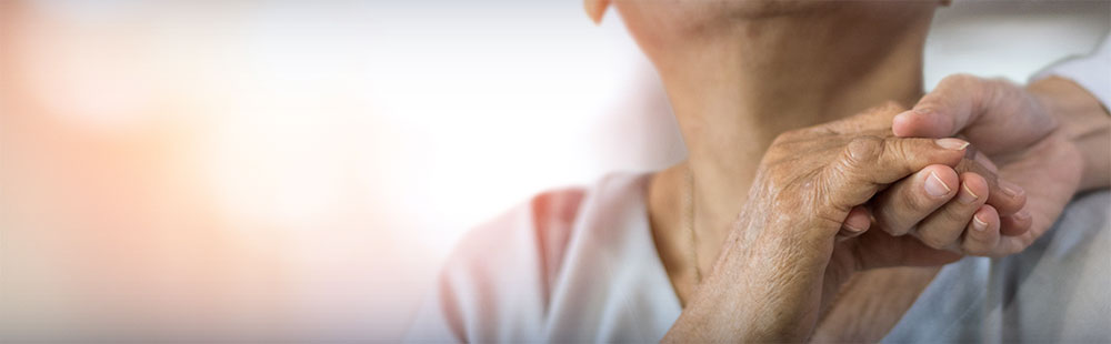 woman's hand held over her shoulder