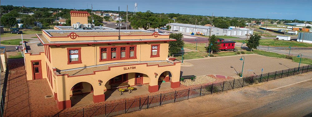 Slaton Harvey House, a former Fred Harvey dining room, later the Atchison, Topeka, & Santa Fe Depot.  Now a museum, events center, and Bed & Breakfast Inn.  Also pictured is a restored circa 1912 Caboose.