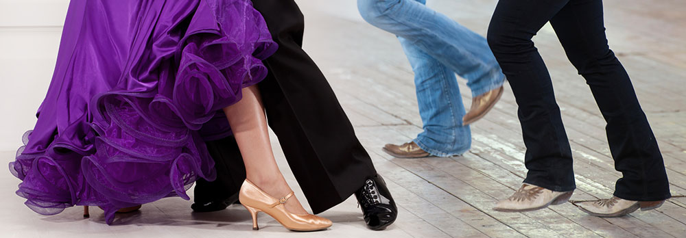 closeup of ballroom and country western dancers' feet on dance floor