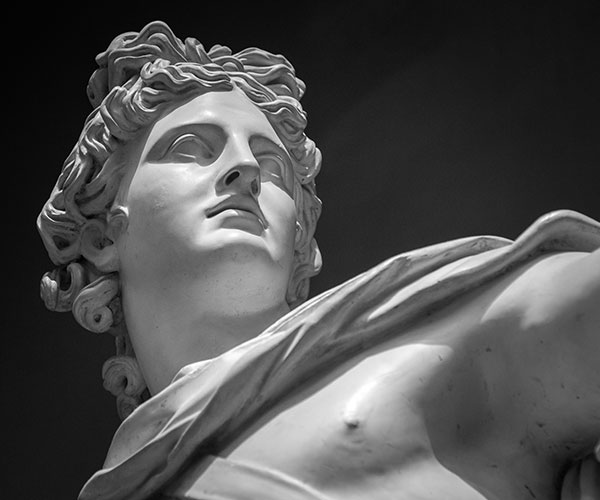 Closeup of a statue of Apollo.
