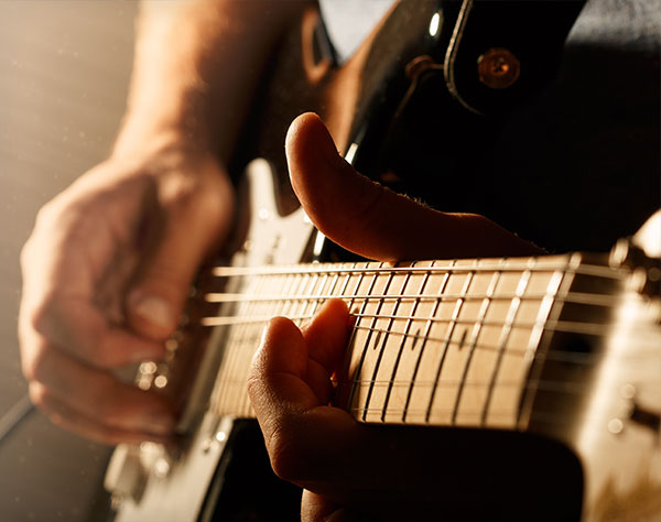 Hands of man playing electric guitar. 