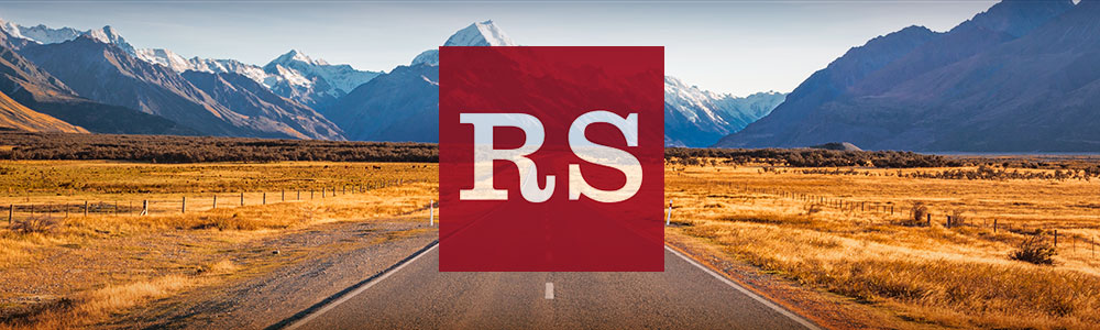  Road Scholar logo imposed over an image of a road leading into the mountains beyond the horizon.