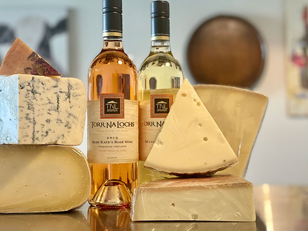 Assortment of wine and cheese on table.