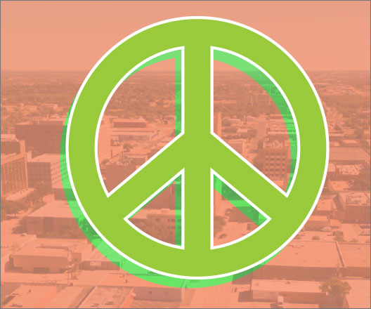 Peace sign superimposed over a photo of Lubbock