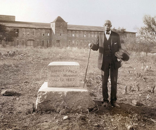 Adam R. Johnson poses with the founder's stone for the city of Marble Falls in July 1887.