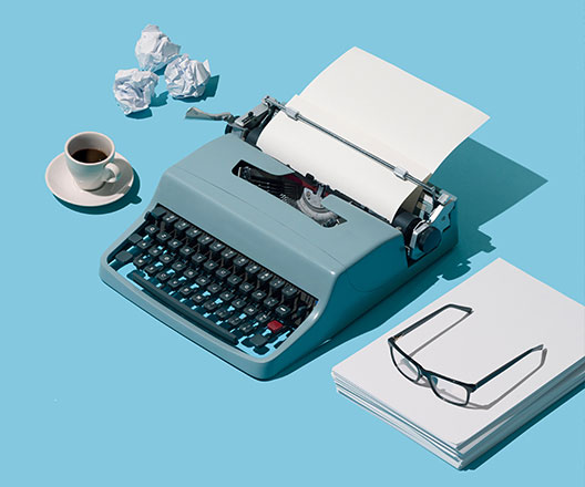 Typewriter, paper, glasses, coffee