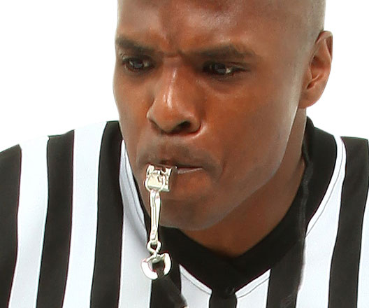 Close-up of a referee with whistle.