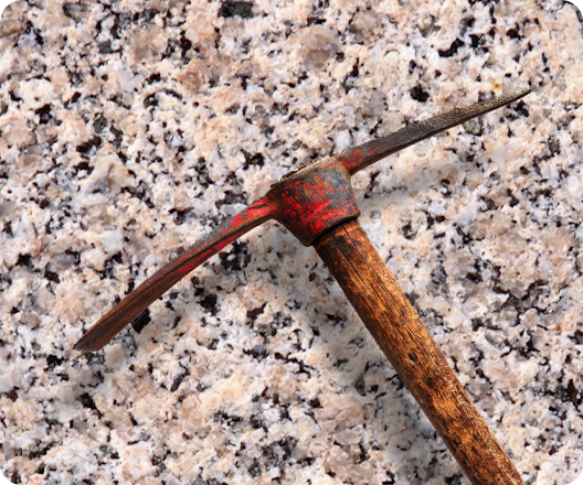 pickaxe over pink granite