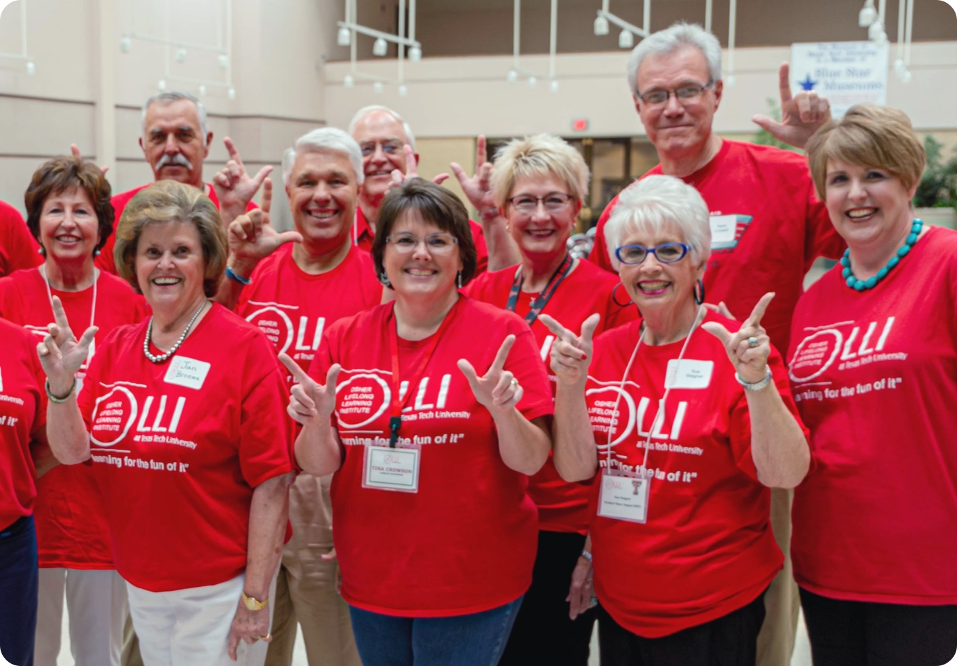 people wearing shirts with OLLI logo